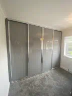 Stone Grey full panel glass doors in polished silver frames, fitted in Middlesbrough
